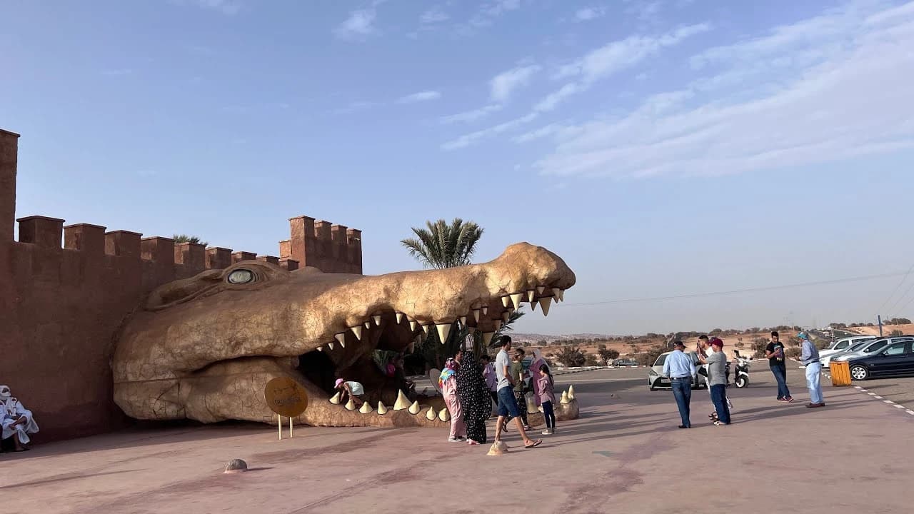 Visitors walking into the giant crocodile-head entrance at Crocoparc Agadir