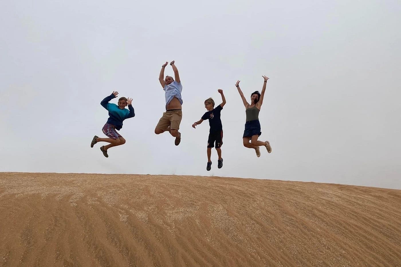 Guests sandboarding on the Timlalin dunes